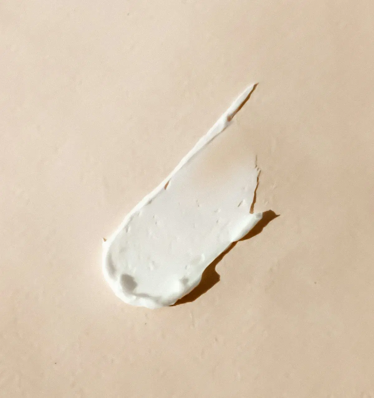 Illustrative cream texture on a neutral surface